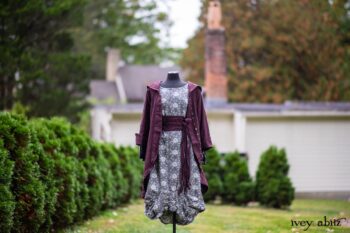 Arthur Hill Duster Coat in Honour Floral Stretch Weave; Porte Cochere Sash in Honour Floral Stretch Weave; Chevaller Cardigan in Unity Soft Ribbed Knit; Scattergood Frock in Unity Floral Linen. Location: Inside Eleanor's rose garden and behind the old forge used to create pewter for Val-Kill Industries, a furnitue and pewter business Eleanor owned and helped operate. When Val-Kill closed, Eleanor turned the factory into her home and the forge into a playhouse for her grandchildren. Eleanor Roosevelt National Historic Site. Hyde Park, New York.