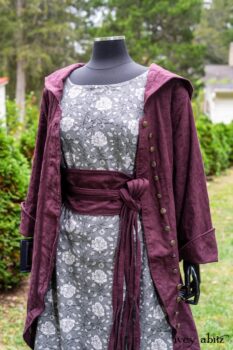 Arthur Hill Duster Coat in Honour Floral Stretch Weave; Porte Cochere Sash in Honour Floral Stretch Weave; Chevaller Cardigan in Unity Soft Ribbed Knit; Scattergood Frock in Unity Floral Linen. Location: Inside Eleanor's rose garden and behind the old forge used to create pewter for Val-Kill Industries, a furnitue and pewter business Eleanor owned and helped operate. When Val-Kill closed, Eleanor turned the factory into her home and the forge into a playhouse for her grandchildren. Eleanor Roosevelt National Historic Site. Hyde Park, New York.