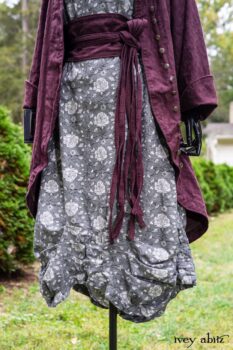 Arthur Hill Duster Coat in Honour Floral Stretch Weave; Porte Cochere Sash in Honour Floral Stretch Weave; Chevaller Cardigan in Unity Soft Ribbed Knit; Scattergood Frock in Unity Floral Linen. Location: Inside Eleanor's rose garden and behind the old forge used to create pewter for Val-Kill Industries, a furnitue and pewter business Eleanor owned and helped operate. When Val-Kill closed, Eleanor turned the factory into her home and the forge into a playhouse for her grandchildren. Eleanor Roosevelt National Historic Site. Hyde Park, New York.