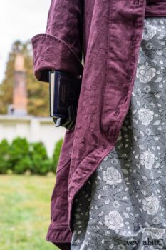 Arthur Hill Duster Coat in Honour Floral Stretch Weave; Porte Cochere Sash in Honour Floral Stretch Weave; Chevaller Cardigan in Unity Soft Ribbed Knit; Scattergood Frock in Unity Floral Linen. Location: Inside Eleanor's rose garden and behind the old forge used to create pewter for Val-Kill Industries, a furnitue and pewter business Eleanor owned and helped operate. When Val-Kill closed, Eleanor turned the factory into her home and the forge into a playhouse for her grandchildren. Eleanor Roosevelt National Historic Site. Hyde Park, New York.