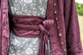 Arthur Hill Duster Coat in Honour Floral Stretch Weave; Porte Cochere Sash in Honour Floral Stretch Weave; Chevaller Cardigan in Unity Soft Ribbed Knit; Scattergood Frock in Unity Floral Linen. Location: Inside Eleanor's rose garden and behind the old forge used to create pewter for Val-Kill Industries, a furnitue and pewter business Eleanor owned and helped operate. When Val-Kill closed, Eleanor turned the factory into her home and the forge into a playhouse for her grandchildren. Eleanor Roosevelt National Historic Site. Hyde Park, New York.