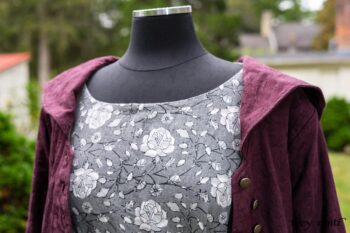 Arthur Hill Duster Coat in Honour Floral Stretch Weave; Porte Cochere Sash in Honour Floral Stretch Weave; Chevaller Cardigan in Unity Soft Ribbed Knit; Scattergood Frock in Unity Floral Linen. Location: Inside Eleanor's rose garden and behind the old forge used to create pewter for Val-Kill Industries, a furnitue and pewter business Eleanor owned and helped operate. When Val-Kill closed, Eleanor turned the factory into her home and the forge into a playhouse for her grandchildren. Eleanor Roosevelt National Historic Site. Hyde Park, New York.
