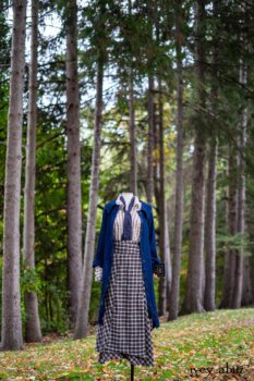 Chittister Duster Coat in Liberty Pin Tuck Twill; Pierrepont Shirt in Dignity Washed Vine Silk; Fairholme Necktie in Liberty Washed Crinkled Weave; Fairholme Skirt in Dignity Plaid Cotton. Location: Path behind house and next to pond at the Eleanor Roosevelt National Historic Site. Val-Kill, Hyde Park, New York.