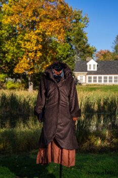 Eleanora Duster Coat in Dignity Soft Wale Corduroy; Truitt Shirt Jacket in Independence Embroidered Washed Silk; Baedeker Scarf in Unity Floral Silk Velvet; Eleanora Frock in Independence Washed Linen. Location: In front of creek and Stone Cottage at the Eleanor Roosevelt National Historic Site. Val-Kill, Hyde Park, New York.