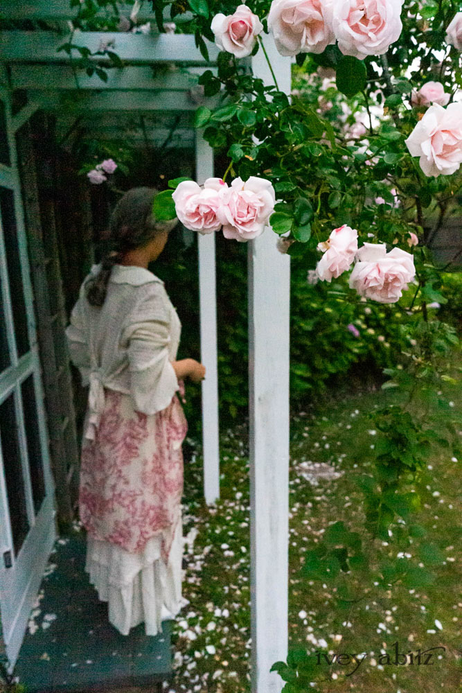 Crest Jacket in Ethereal Cream Lace Netted Knit; Crest Frock in Cape Rose Floral Voile; Blanchefleur Sash in Cape Rose Floral Voile; Heraldry Frock in Cape Rose Floral Voile. Ivey Abitz Bespoke Clothing.