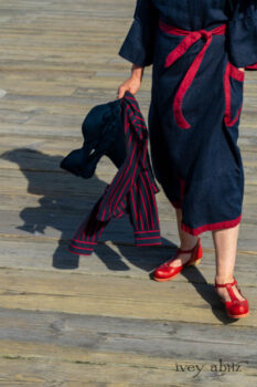 Sennen Jacket in National Seashore Washed Linen with Cape Rose Washed Linen details; Sennen Frock in National Seashore Washed Linen with Cape Rose Washed Linen detail; Limited Edition Gilbert Cardigan in National Seashore and Red Stripe Knit. Ivey Abitz Bespoke Clothing.