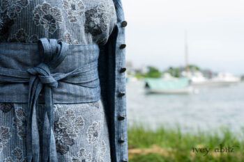 Tilbrook Duster Coat in Seascape Woven Linen; Tilbrook Frock in Seascape Floral Linen; Porte Cochere Sash in Estuary Herringbone Twill. Ivey Abitz Bespoke Clothing.