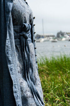 Tilbrook Duster Coat in Seascape Woven Linen; Tilbrook Frock in Seascape Floral Linen; Porte Cochere Sash in Estuary Herringbone Twill. Ivey Abitz Bespoke Clothing.