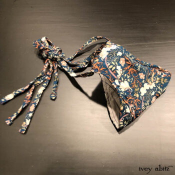 Bespoke mask with two layers of tightly woven cotton on the inside and adorned with our Independence Floral Vine Weave on the outside.