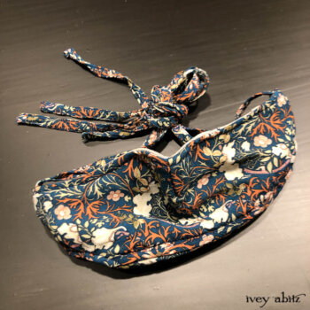 Bespoke mask with two layers of tightly woven cotton on the inside and adorned with our Independence Floral Vine Weave on the outside.