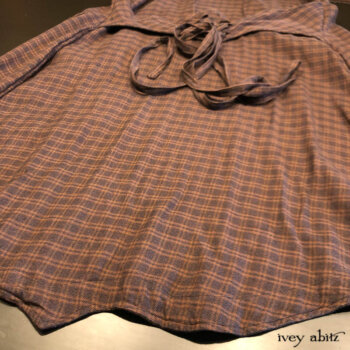 Back bottom hem detail of the Heraldry Vest with optional lacing in back.