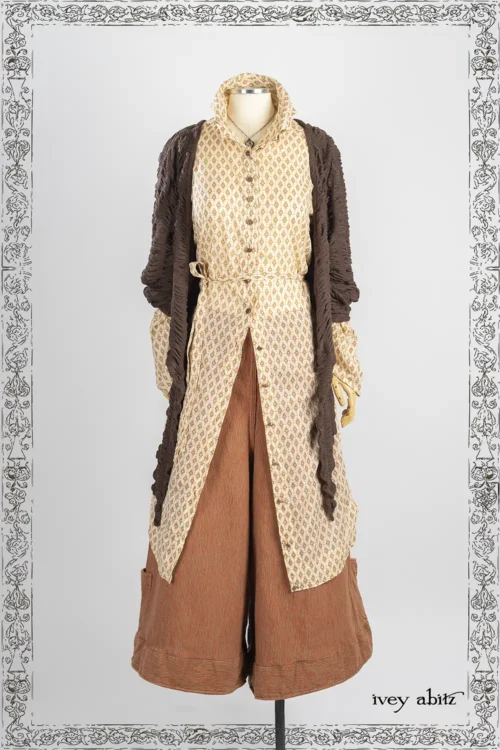 Wright Cardigan in Oak Puckered Knit; Cedar Lake Dress Shirt in Heirloom Oak Floral Motif Voile; Montague Trousers in Copper and Stone Embroidered Stripe Weave; Nouvelle Necklace.