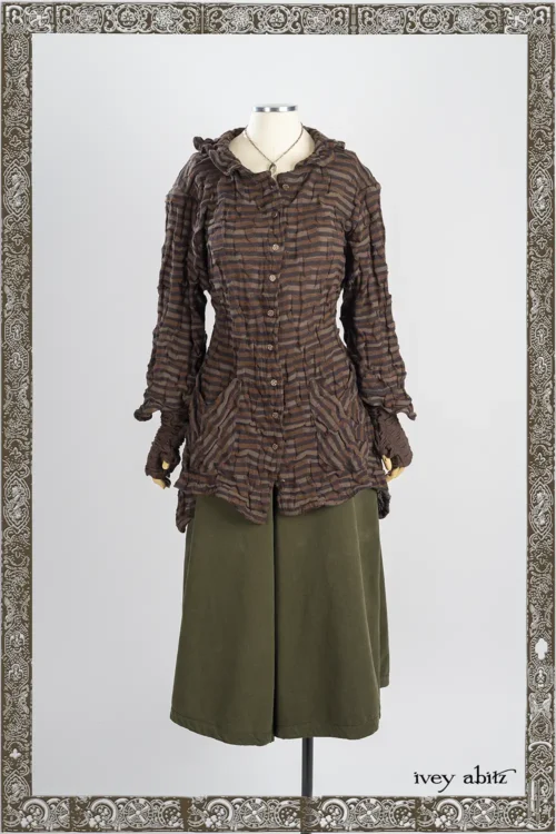 Tula Shirt in Oak Clever Stripe Knit; Nouvelle Necklace; Traipse Trousers in Joyful Green Washed Twill - Reversible to Copper Washed Plaid Twill; Lelant Arm Sleeves in Oak Puckered Knit.