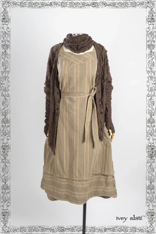 Wright Cardigan in Oak Puckered Knit; Lelant Arm Sleeves in Oak Puckered Knit; Lelant Neck Wrap in Oak Puckered Knit; Oceana Frock in Lifetime Washed Plaid Twill; Heirloom Necklace.