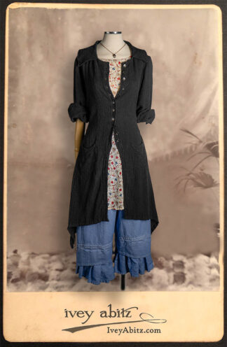 Elsie Duster Coat in Black Puckered Check Weave; Wildefield Frock in Brooklyn Floral Silk Chiffon; Blanchefleur Trousers in British Workaday Weave; Nouvelle Necklace.