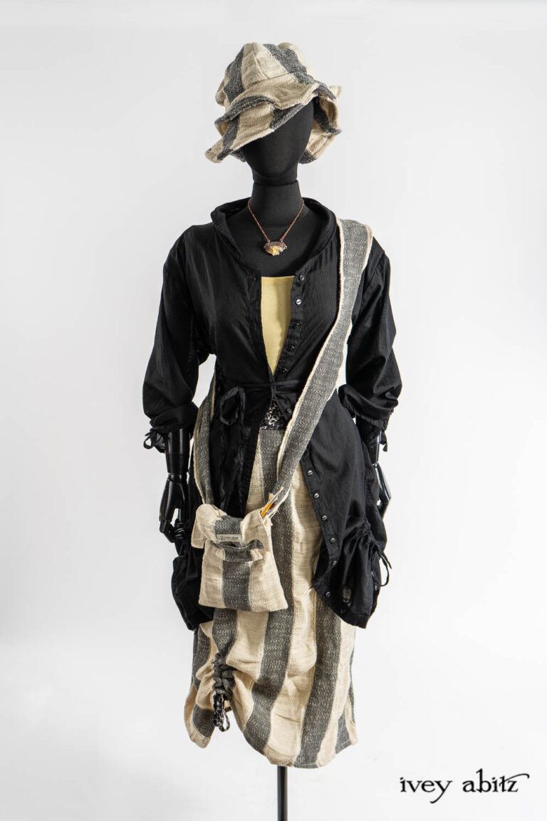 Voyage Satchel in Post Modern Old World Stripe; Riverside Duster Coat in Post Modern Petite Stripe Voile; Cilla Camisole in Dada Silkiest Knit; Riverside Skirt in Post Modern Old World Stripe; Hapgood Hat in Post Modern Old World Stripe; Renaissance Necklace.