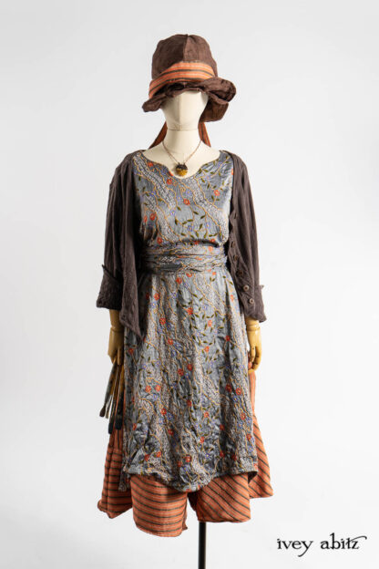 Liberté Jacket in Realism Embroidered Stripe Knit; Nook Frock in Raphaelite Embroidered Washed Silk; Porte Cochere Sash in Raphaelite Embroidered Washed Silk; Cossart Culottes in Fauvist Raised Stripe Weave; Fitz Necktie in Fauvist Raised Stripe Weave; Hapgood Hat in Realism Crushed Weave; Renaissance Necklace.