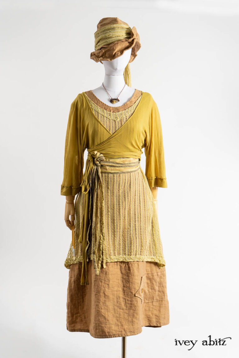 Tuileries Wrap Jacket in Dada Ethereal Knit; Ettienne Frock in Dada Embroidered Stripe Knit; Baedeker Frock in Art Nouveau Washed Crushed Weave; Hapgood Hat in Art Nouveau Washed Crushed Weave; Ettienne Sash in Dada Embroidered Stripe Knit; Renaissance Necklace.