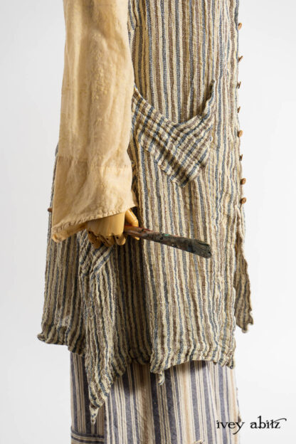 Ellis Frock in Academic and Realism Rustic Stripe; Ellis Shirt in Baroque Flocked Floral Voile; Camilla Trousers in Academic Woven Stripe; Hapgood Hat in Academic Finest Everyday Weave; Clotaire Sash in Academic Rustic Stripe; Nouvelle Necklace.