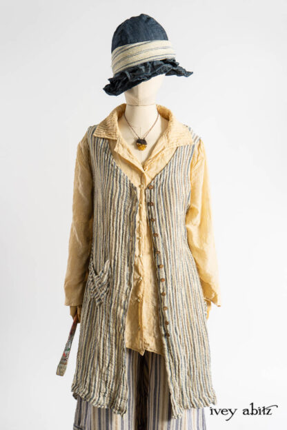 Ellis Frock in Academic and Realism Rustic Stripe; Ellis Shirt in Baroque Flocked Floral Voile; Camilla Trousers in Academic Woven Stripe; Hapgood Hat in Academic Finest Everyday Weave; Clotaire Sash in Academic Rustic Stripe; Nouvelle Necklace.