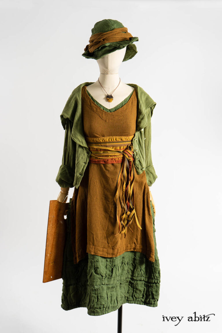 Eleanora Jacket in Impressionism Ethereal Silk Cloth; Ettienne Frock in Medieval Wispy Woven Silk; Porte Cochere Sash in Medieval Puckered Stripe Weave; Manor Frock in Renaissance Saturated Weave; Hapgood Hat in Renaissance Saturated Weave; Ettienne Sash in Medieval Wispy Woven Silk; Renaissance Necklace.