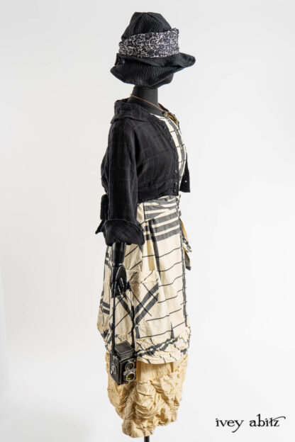 Beacon Jacket in Post Modern Puckered Wispy Weave; Mewland Vest in Post Modern Bold Puckered Plaid; Fitzgerald Frock in Baroque Textured Stretch Weave; Hapgood Hat in Post Modern Puckered Wispy Weave; Eleanora Sash in Post Modern Floral Ethereal Weave; Nouvelle Necklace;