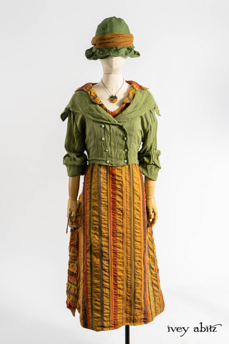 Eleanora Jacket in Impressionism Ethereal Silk Cloth; Vanetten Frock in Medieval Puckered Stripe; Hapgood Hat in Renaissance Saturated Weave; Ettienne Sash in Medieval Wispy Woven Silk; Renaissance Necklace.
