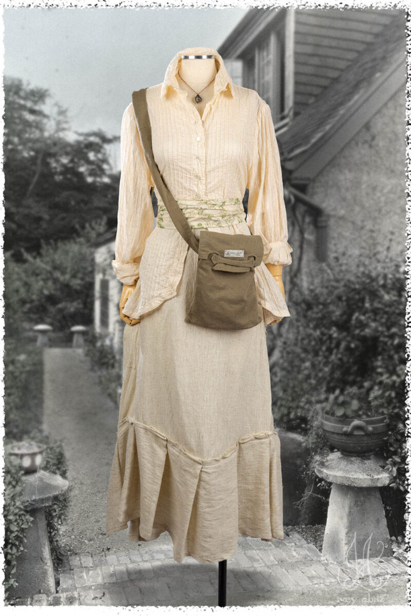 Ivey Abitz Summer 2025 Look 11 Truitt Shirt in Cottage Cream Pintucked Voile; Fairholme Skirt in Cottage Cream Rustic Weave; Cilla Slip Frock in Everyday Ribbed Knit; Blanchefleur Sash in Garden Floral Washed Weave; Voyage Satchel in Garden Ribbed Washed Twill; Nouvelle Necklace.