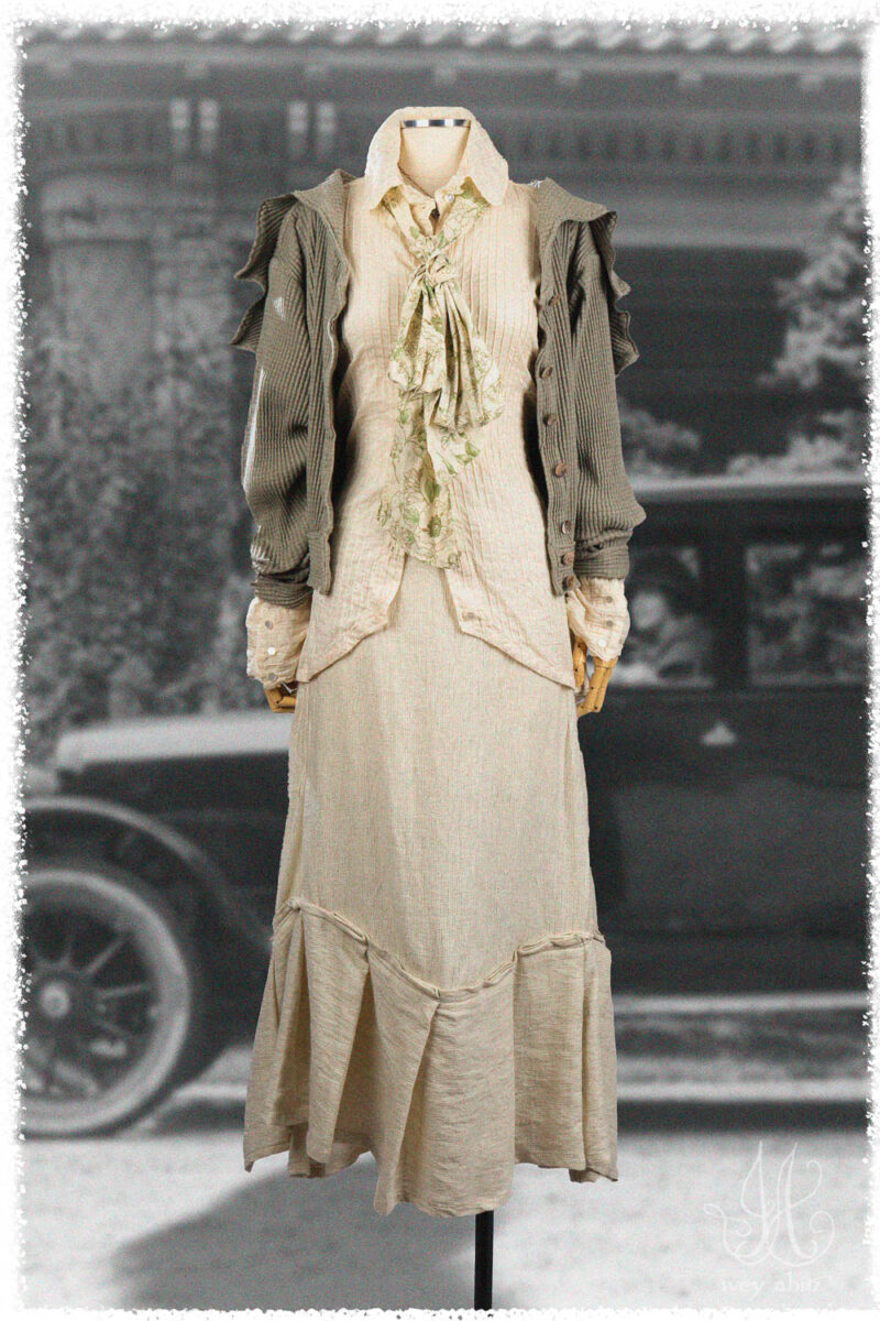 Ivey Abitz Summer 2025 Look 12 Truitt Shirt in Cottage Cream Pintucked Voile; Roycroft Cardigan in Garden Ribbed Knit; Blanchefleur Sash in Garden Floral Washed Weave; Fairholme Skirt in Cottage Cream Rustic Weave.