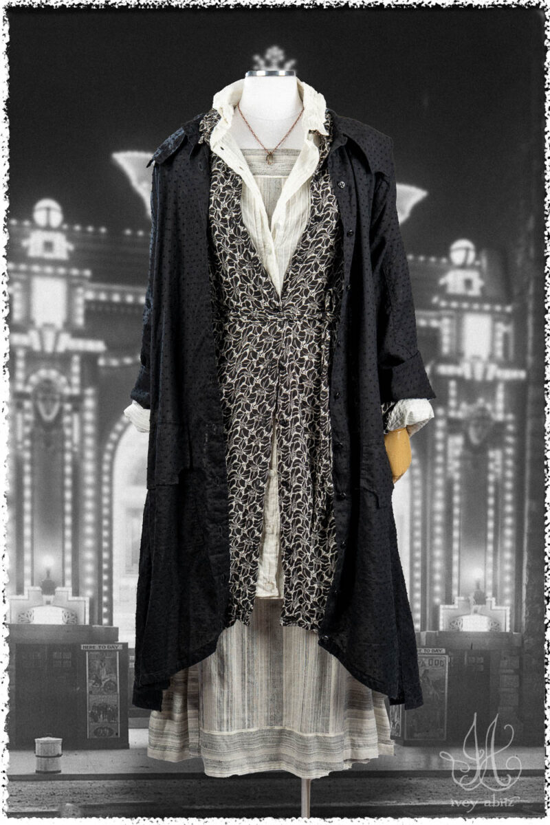 Ivey Abitz Summer 2025 Look 31 Roycroft Duster Coat in Black Dotted Check Voile; Vanetten Shirt in Black Floral Soft Crepe; Vanetten Shirt in Signature Everyday Pintucked Voile; Roycroft Frock in Black and White Variegated Washed Stripe; Nouvelle Necklace.