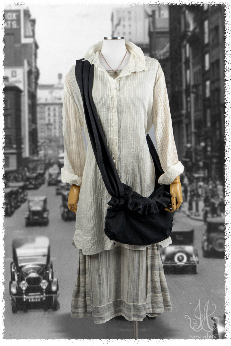 Ivey Abitz Summer 2025 Look 35 Vanetten Shirt in Signature Everyday Pintucked Voile; Roycroft Frock in Black and White Variegated Washed Stripe; Cozette Bag in Black Ribbed Washed Twill; Nouvelle Necklace.