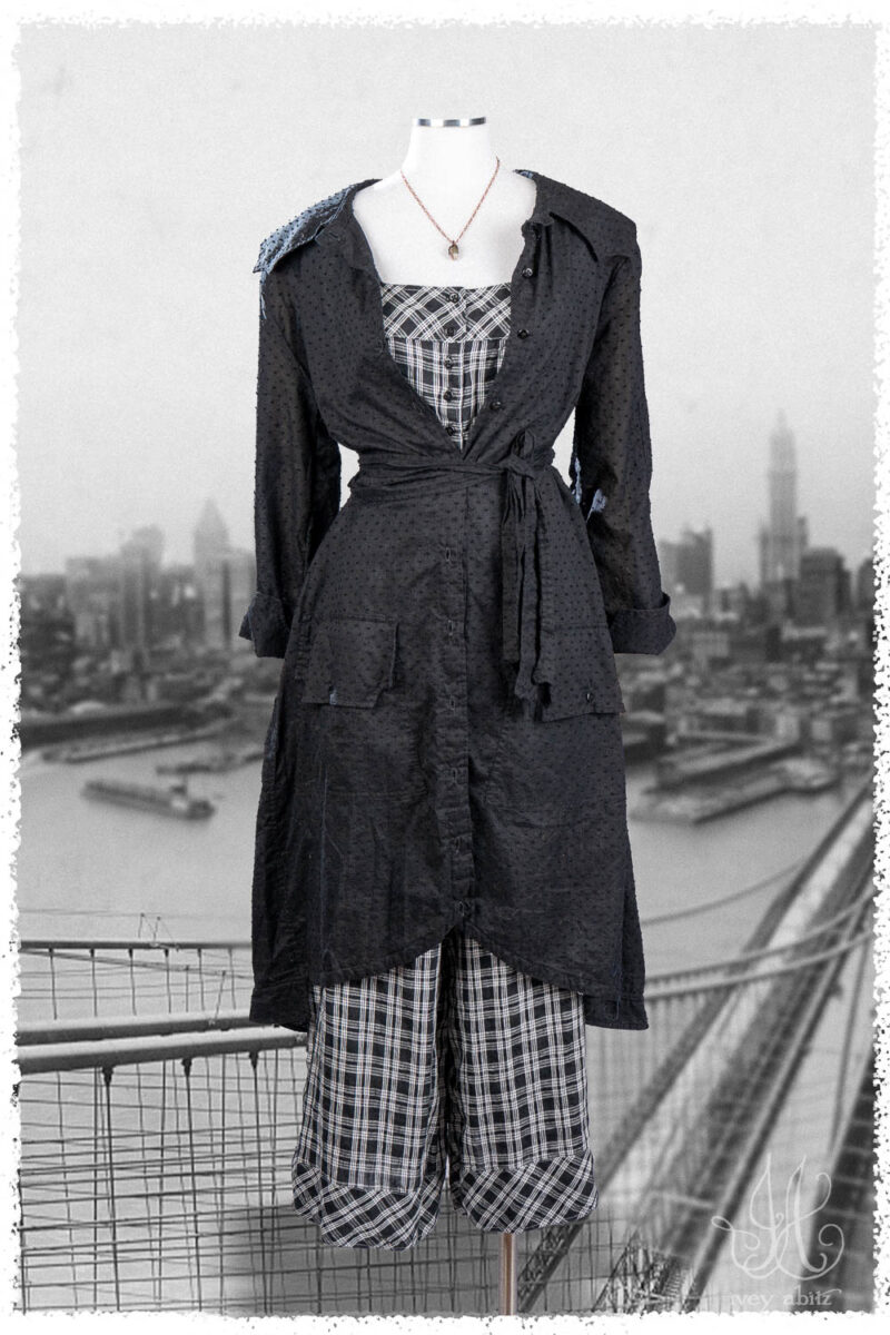 Ivey Abitz Summer 2025 Look 36 Roycroft Duster Coat in Black Dotted Check Voile; Roycroft Vest in Black and White Soft Plaid; Roycroft Trousers in Black and White Soft Plaid; Nouvelle Necklace.