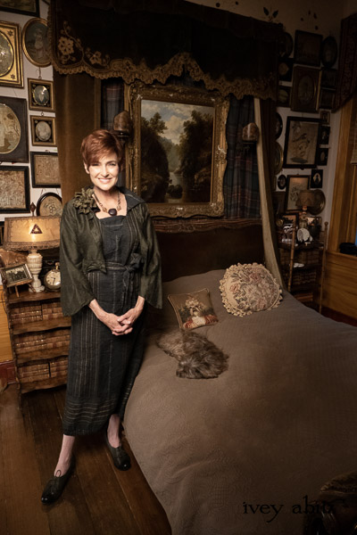 Eugenia Jacket in Olive Quartz Washed Textured Silk; Bonheur Sash in Olive Quartz Sculpted Felt; Viv Frock in Olive Quartz Embroidered Stripe Weave; Nouvelle Necklace. - Bespoke clothing by Ivey Abitz. Featuring Carolyn Hennesy with rescue dogs and cats.