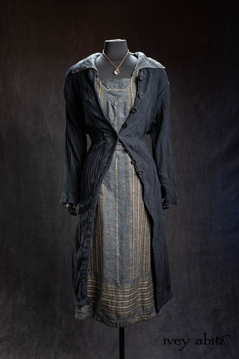 Maplehurst Duster Coat in Black Diamond Double Crinkled Stretch Voile; Viv Frock in Olive Quartz Embroidered Stripe Weave; Nouvelle Necklace. - Bespoke clothing by Ivey Abitz.