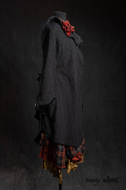 Chevallier Duster Coat in Black Diamond Heirloom Puckered Stretch Weave; Bonheur Brooch in Ruby Sculpted Felt; Chomley Frock in Scottish Gem Plaid Gauze; Inglenook Frock in Scottish Gem Crushed Silk; Inglenook Frock in Brass Crushed Silk; Nouvelle Necklace. - Bespoke clothing by Ivey Abitz.