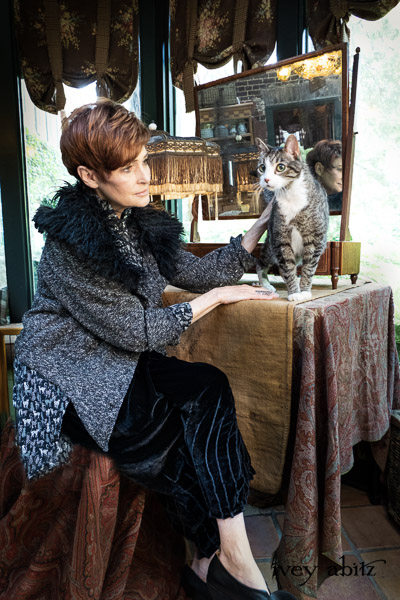 Coulson Cardigan in Black Diamond Nubby Knit; Pemberley Shirt Black Diamond Cool Cat Weave; Nouvelle Necklace; Lydia Trousers in Black Diamond Silk Velvet. - Bespoke clothing by Ivey Abitz. Featuring Carolyn Hennesy with rescue dogs and cats.