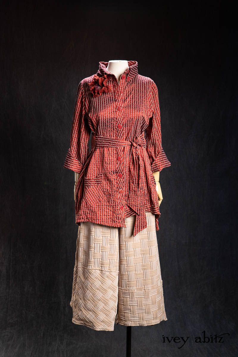 Highlands Shirt in Ruby Embroidered Stripe Silk; Bonheur Brooch in Ruby Sculpted Felt; Cossart Culottes in Stone Heirloom Puckered Stretch Weave. - Bespoke clothing by Ivey Abitz.