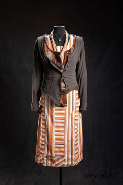 Limited Edition Gilbert Cardigan in Earth and Iron Petite Stripe Knit; Elliot Vest in Copper Argyle Knit; Highlands Sash in Copper Petite Fleur Knit; Campanella Frock in Copper Striped Poplin; Nouvelle Necklace. - Bespoke clothing by Ivey Abitz.