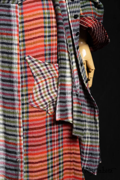 Highlands Shirt in Ruby Embroidered Stripe Silk; Bonheur Brooch in Ruby Sculpted Felt; Highlands Duster Coat in Gem Softest Plaid Wool; Highlands Skirt in Gem Softest Plaid Wool; Nouvelle Necklace. - Bespoke clothing by Ivey Abitz.