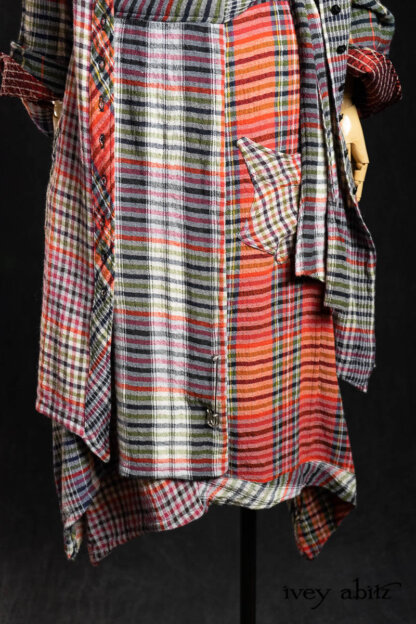 Highlands Shirt in Ruby Embroidered Stripe Silk; Bonheur Brooch in Ruby Sculpted Felt; Highlands Duster Coat in Gem Softest Plaid Wool; Highlands Skirt in Gem Softest Plaid Wool; Nouvelle Necklace. - Bespoke clothing by Ivey Abitz.
