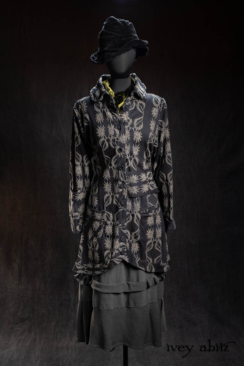 Montague Coat in Floral and Fauna Brocade; Ellis Sash in Olive Quartz Silk Velvet; Hapgood Hat in Black Diamond Crushed Velvet; Hudson Frock in Olive Quartz Crinkled Weave; Limited Edition Gilbert Cardigan in Earth and Iron Petite Stripe Knit. - Bespoke clothing by Ivey Abitz.