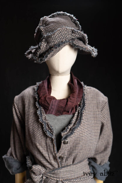 Bonheur Hat in Pewter and Amethyst Houndstooth Wool; Chevallier Frock in Pewter Cashmere Cotton Twill; Heirloom Sash in Amethyst Embroidered Puckered Organza; Bonheur Shirt Jacket in Pewter and Amethyst Houndstooth Wool. - Bespoke clothing by Ivey Abitz.