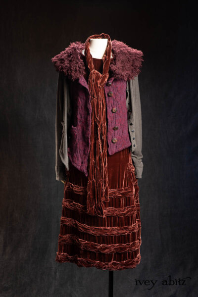 Coulson Vest in Amethyst Boiled Wool Knit; Tollie Sash in Amethyst Silk Velvet; Limited Edition Gilbert Cardigan in Earth and Iron Petite Stripe Knit; Bertie Frock in Amethyst Silk Velvet; Cilla Slip Frock in Signature Black Washed Silk Jersey Knit. - Bespoke clothing by Ivey Abitz.