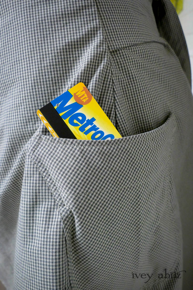 Eleanora Duster Coat in Slate Petite Check Coat Weave; Eleanora Frock in Central Park and Uptown Plaid Linen; Cape Frock in Central Park Washed Linen; Lydia Neck Wrap in Signature Beacon Melange Knit; Bespoke Mask in Slate Washed Knit. - Ivey Abitz Bespoke Clothing