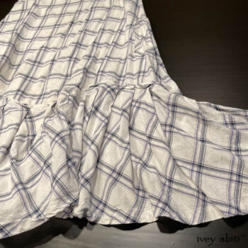 Bottom hem detail of the Fairholme Frock in our Plum Tree Wispy Washed Weave.