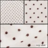 Description: Perhaps it is obvious by now, but the dots are symbolic of the record shape and musical theme of the More Collection. The circle is symbolic of life itself. It gives us assurance and hope.The soft white base allows the brown embroidered circles (records) to repeat beautifully across the weave. It is a softly crinkled silk chiffon, created with the finest threads. It is an ideal choice for shirts, lightweight layering jackets, layering frocks, and sashes. Content: The finest one hundred percent silk. Care: Simply hand wash or put through machine delicate cycle in cold water with a plant based detergent. We suggest using a natural fabric softener to maintain the softness we have washed into it. Tumble dry on extra-low heat with our artisan wool dryer balls to keep the relaxed effect that is featured in the Look Book.