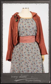 Bertie Jacket in New Sun Softest Knit; Floravinea Brooch in Rosy Washed Crinkled Linen; Tilbrook Frock in Fresh Water Floral Weave; Edenshire Frock in New Sun Washed Linen in High Water Length; Porte Cochere Sash in Rosy Washed Cotton. By Ivey Abitz.