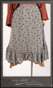 Bertie Jacket in New Sun Softest Knit; Floravinea Brooch in Rosy Washed Crinkled Linen; Tilbrook Frock in Fresh Water Floral Weave; Edenshire Frock in New Sun Washed Linen in High Water Length; Porte Cochere Sash in Rosy Washed Cotton. By Ivey Abitz.