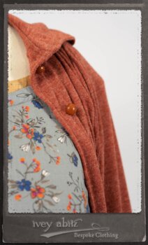 Bertie Jacket in New Sun Softest Knit; Floravinea Brooch in Rosy Washed Crinkled Linen; Tilbrook Frock in Fresh Water Floral Weave; Edenshire Frock in New Sun Washed Linen in High Water Length; Porte Cochere Sash in Rosy Washed Cotton. By Ivey Abitz.