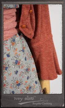 Bertie Jacket in New Sun Softest Knit; Floravinea Brooch in Rosy Washed Crinkled Linen; Tilbrook Frock in Fresh Water Floral Weave; Edenshire Frock in New Sun Washed Linen in High Water Length; Porte Cochere Sash in Rosy Washed Cotton. By Ivey Abitz.